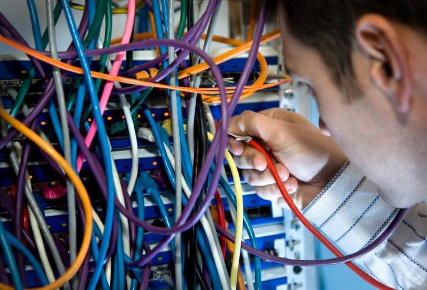 Complex network cables and connections representing outdated Microsoft Access database maintenance.