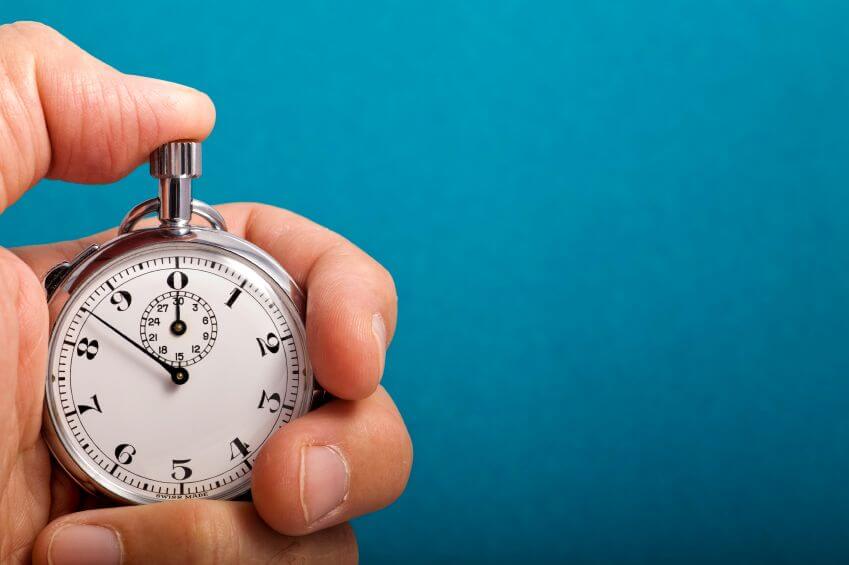 Hand holding blue stopwatch illustrating rapid prototyping and tight deadlines for DuPont.