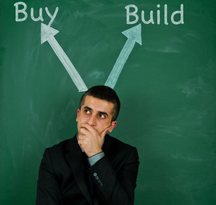 Man contemplating the buy versus build software decision.