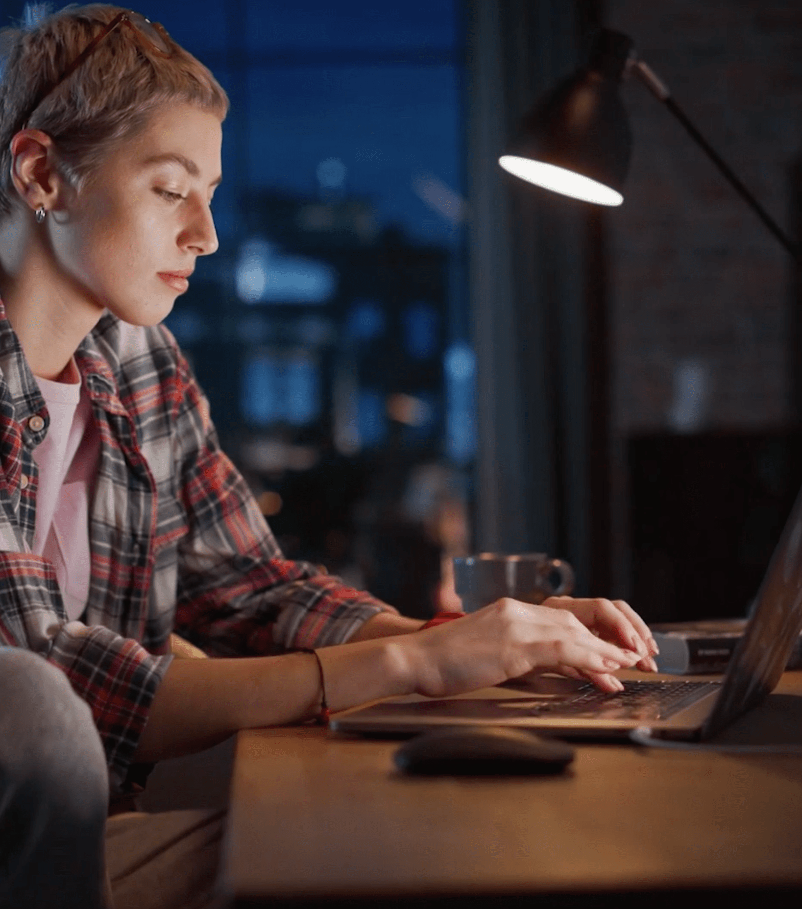 Woman working on laptop illustrating Microsoft Access modernization services.