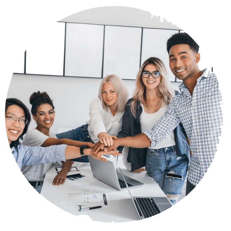 Help4Access team collaborating at desk with laptops and documents, demonstrating expertise in Microsoft Access solutions.