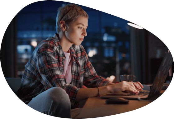 Woman working on laptop illustrating Microsoft Access migration and data modernization services.